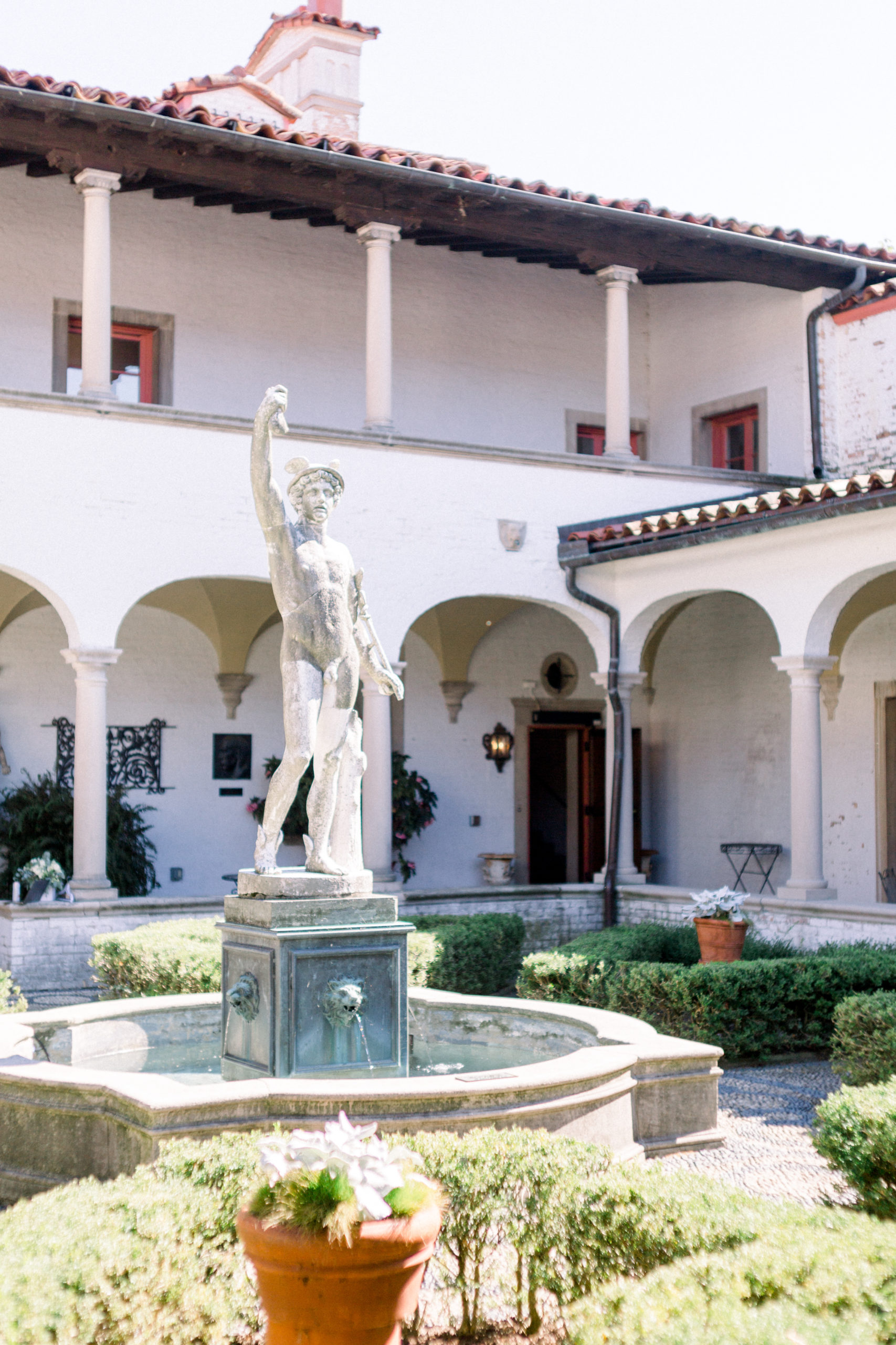 italian stone statue of a man in courtyard