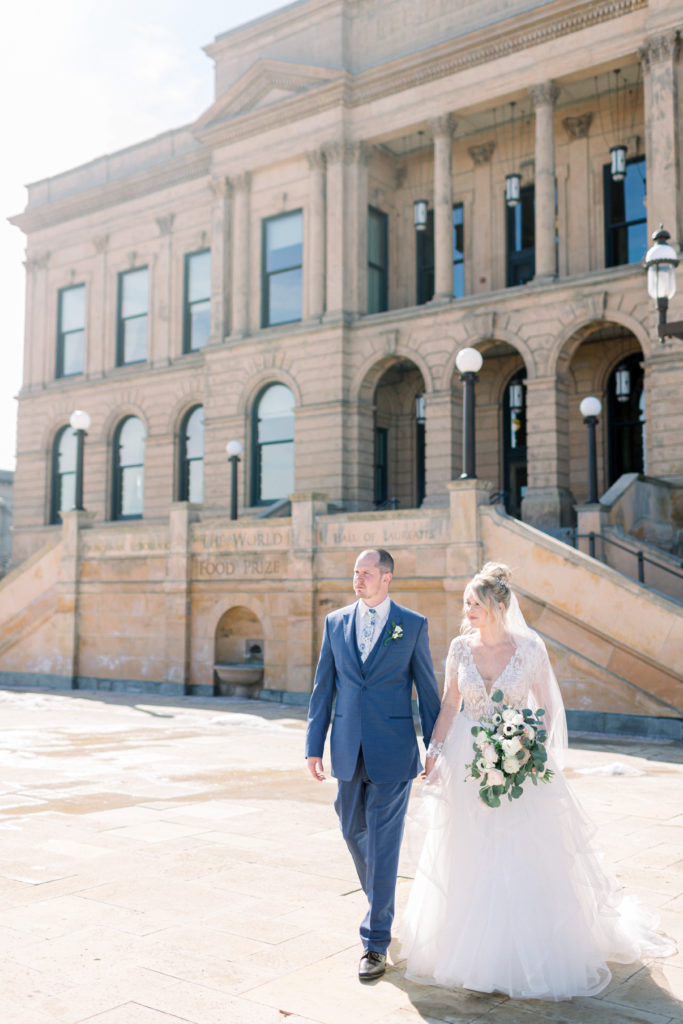 Wedding couple walking in front of World Food Prize building