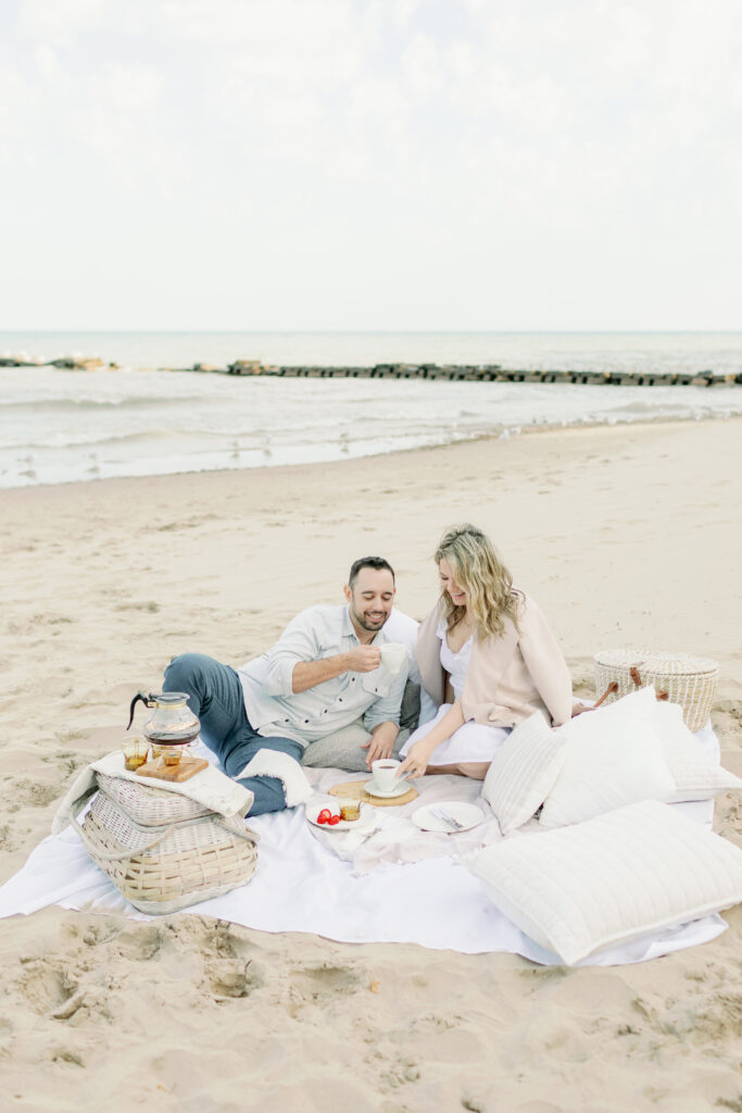 couple drinking coffee on beach
