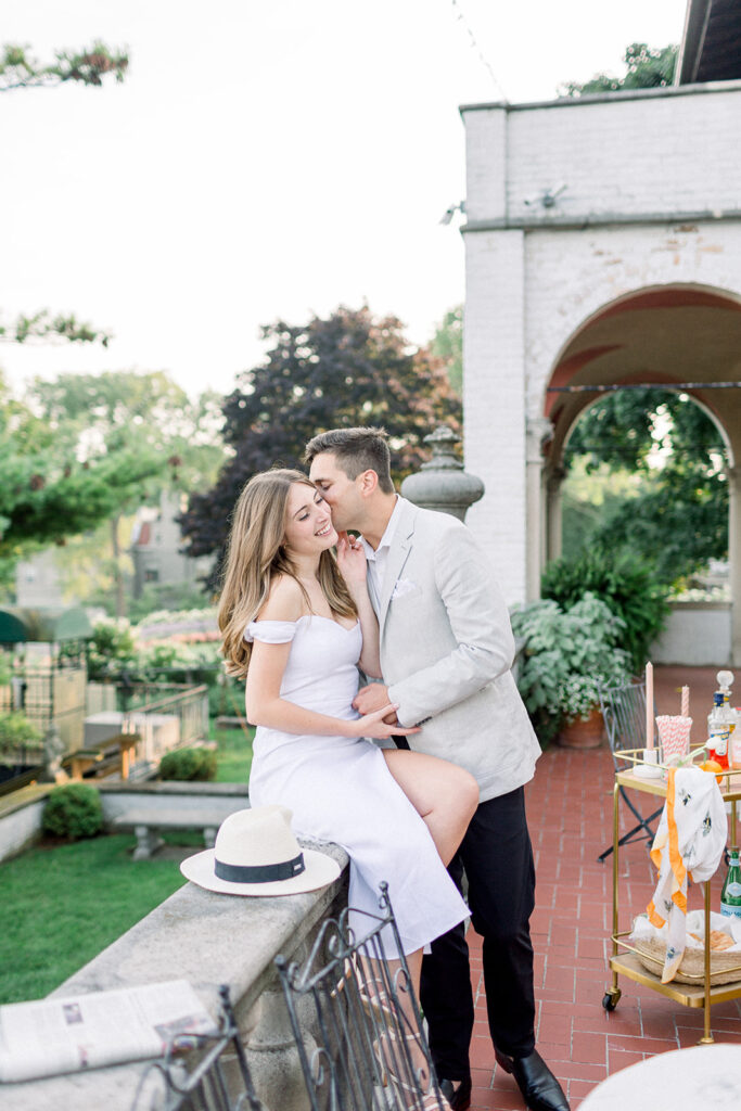 couple kissing on veranda of italian villa