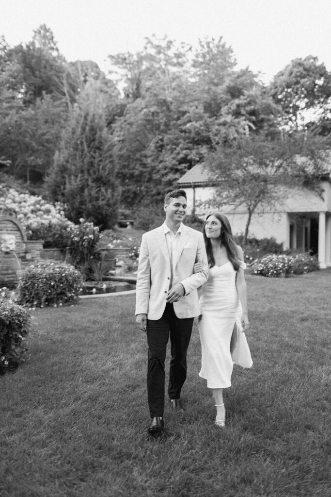 black and white photo of couple walking at italian villa