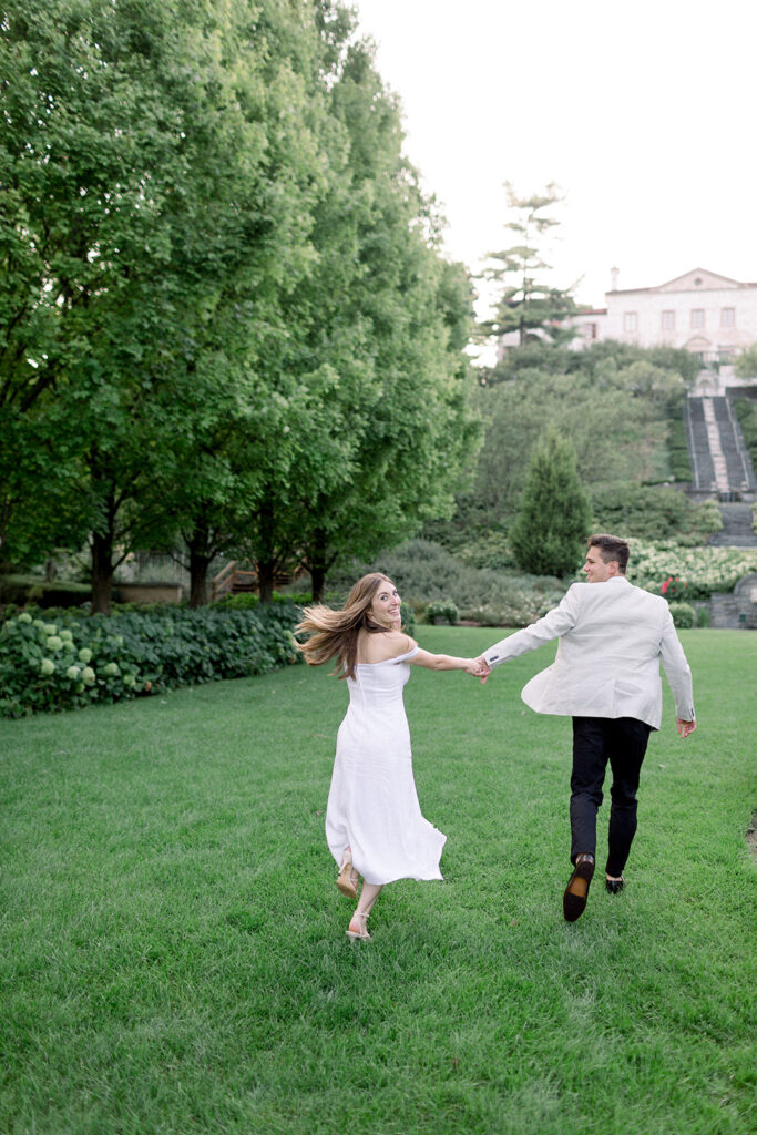 couple running on grass at italian villa