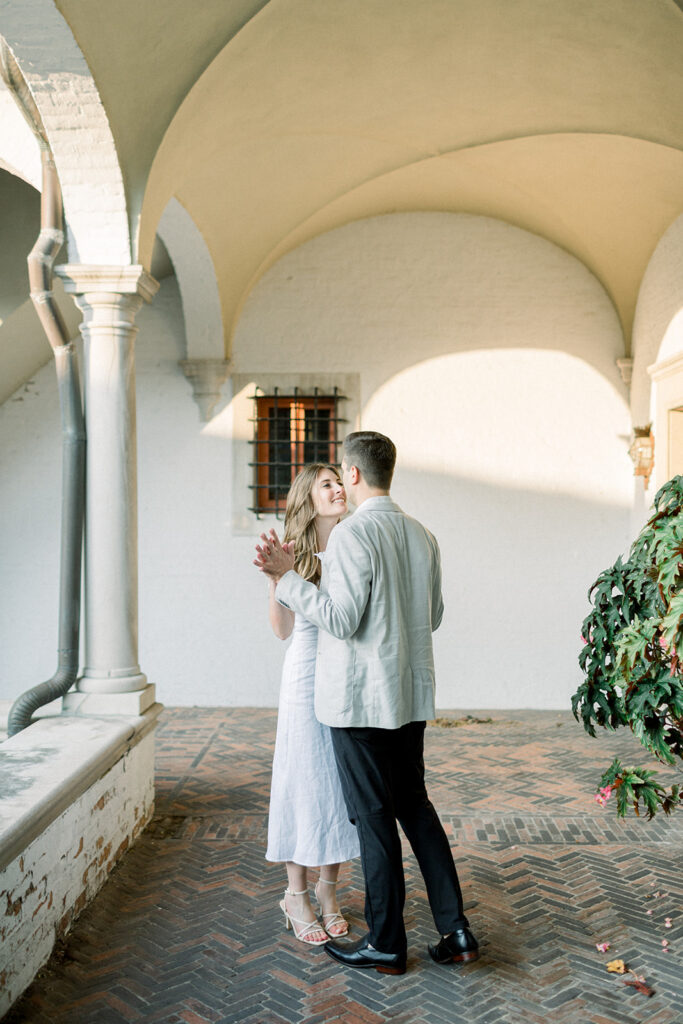 couple dancing in arched hallway at italian villa