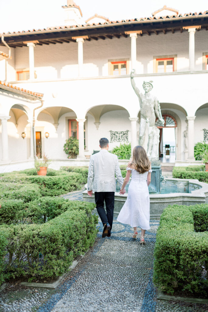 couple walking through italian courtyard