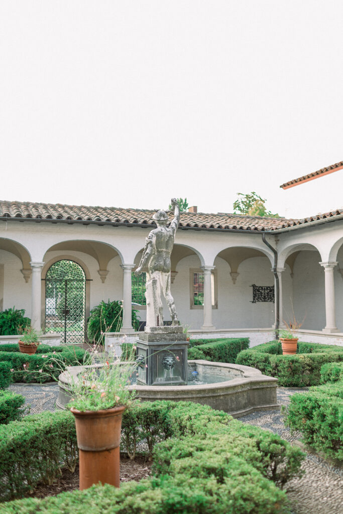 statue of hermes in an italian villa courtyard